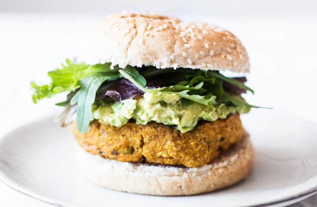 A plant based patty is served on a sesame bread roll.