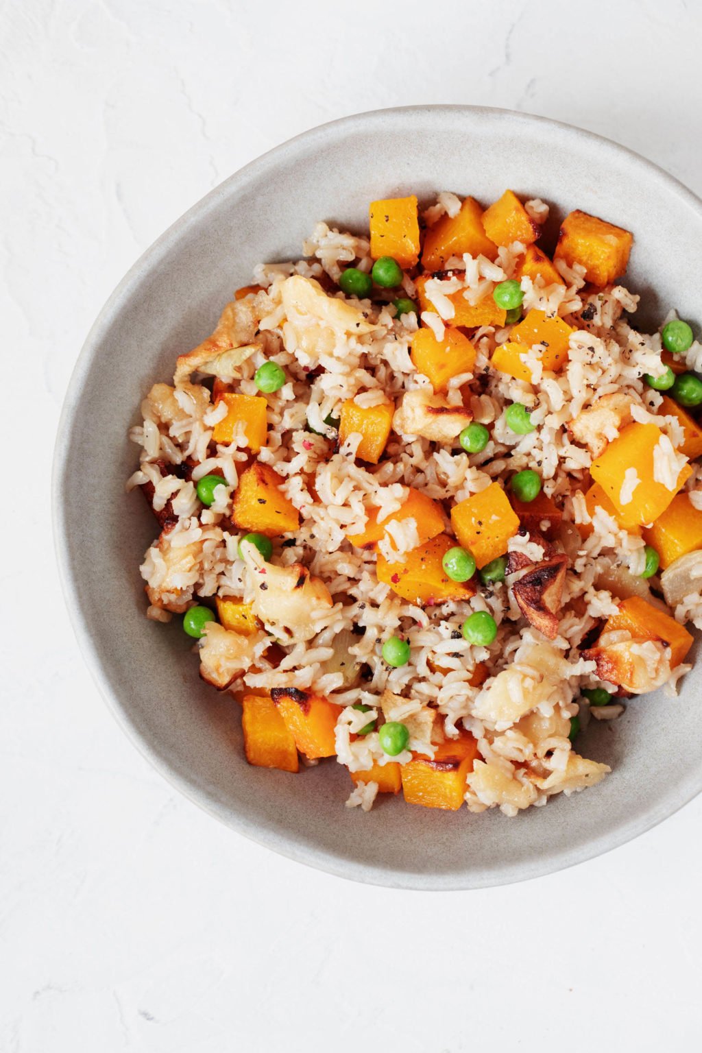 An overhead image of a round bowl of gingery butternut squash rice.