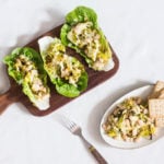 Vegan hors d'oeuvres with beans and crackers have been served, along with lettuce leaves.