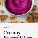 An image of bright pink, creamy roasted beet hummus.