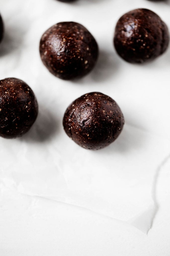 An overhead shot of raw vegan brownie bites, made with dates, cashews, and raw cacao.