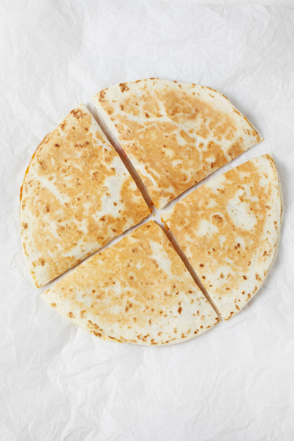 An overhead image of a toasted tortilla "sandwich," with a creamy sweet potato red pepper filling.