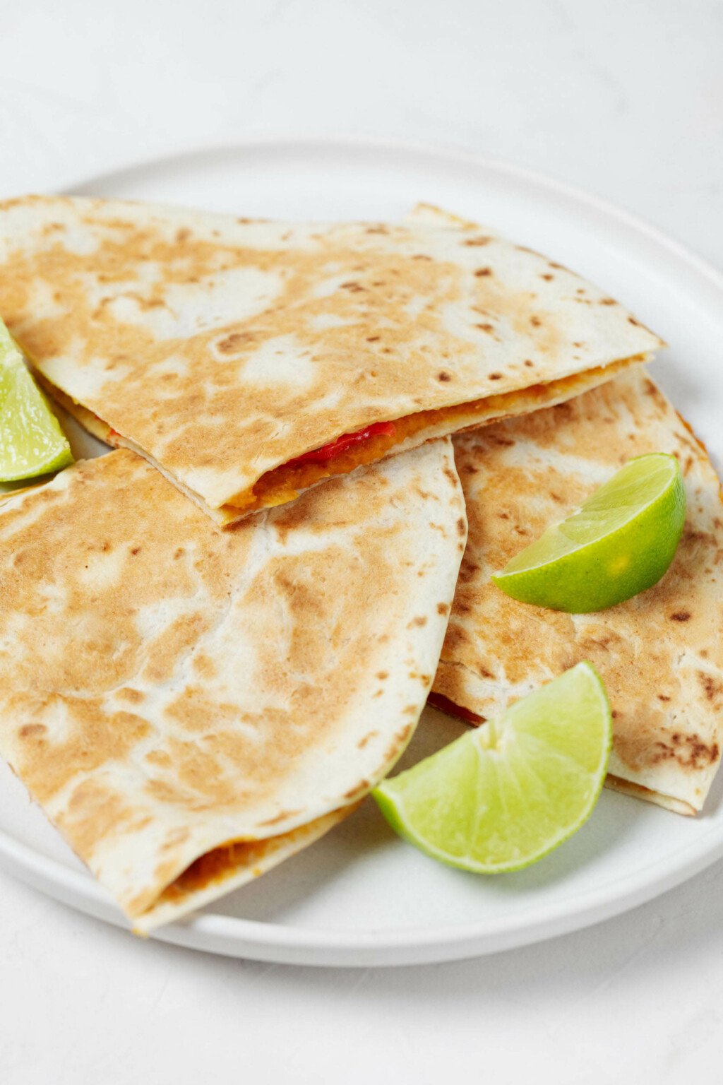 An overhead image of two toasted tortillas, which together create a "sandwich" for a creamy sweet potato filling.