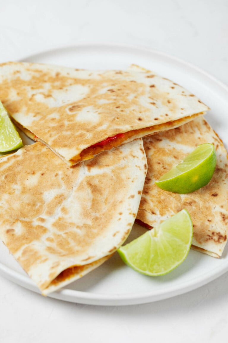 An overhead image of two toasted tortillas, which together create a "sandwich" for a creamy sweet potato filling.