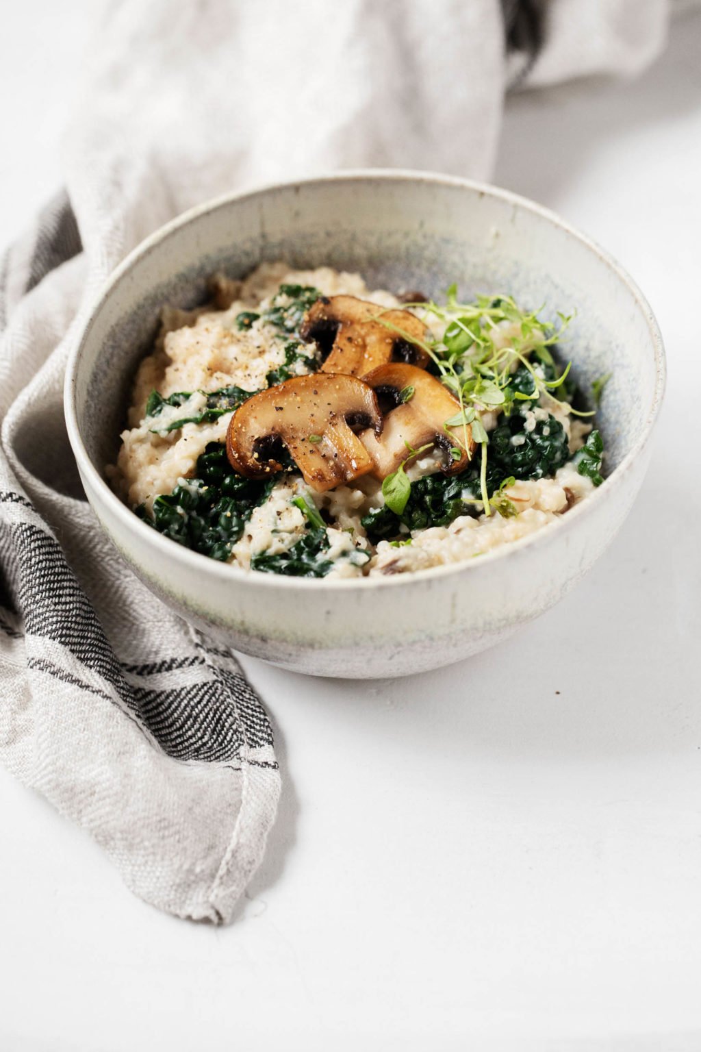 A small, round bowl contains a bowl of savory steel cut oatmeal.