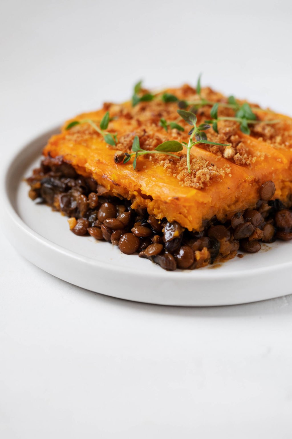 Sauteed lentils and mushrooms are baked with a sweet potato topping and cut into squares.