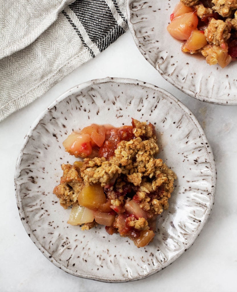An overhead shot of a plate of juicy, gluten free apple, pear and cranberry crisp.