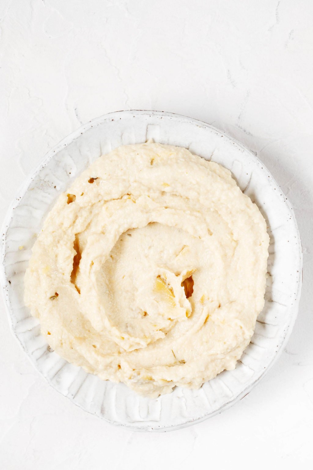 A small dipping bowl holds a creamy bean puree.