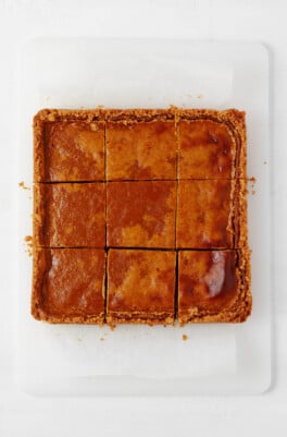 An overhead image of a square of freshly baked vegan pumpkin pie bars.