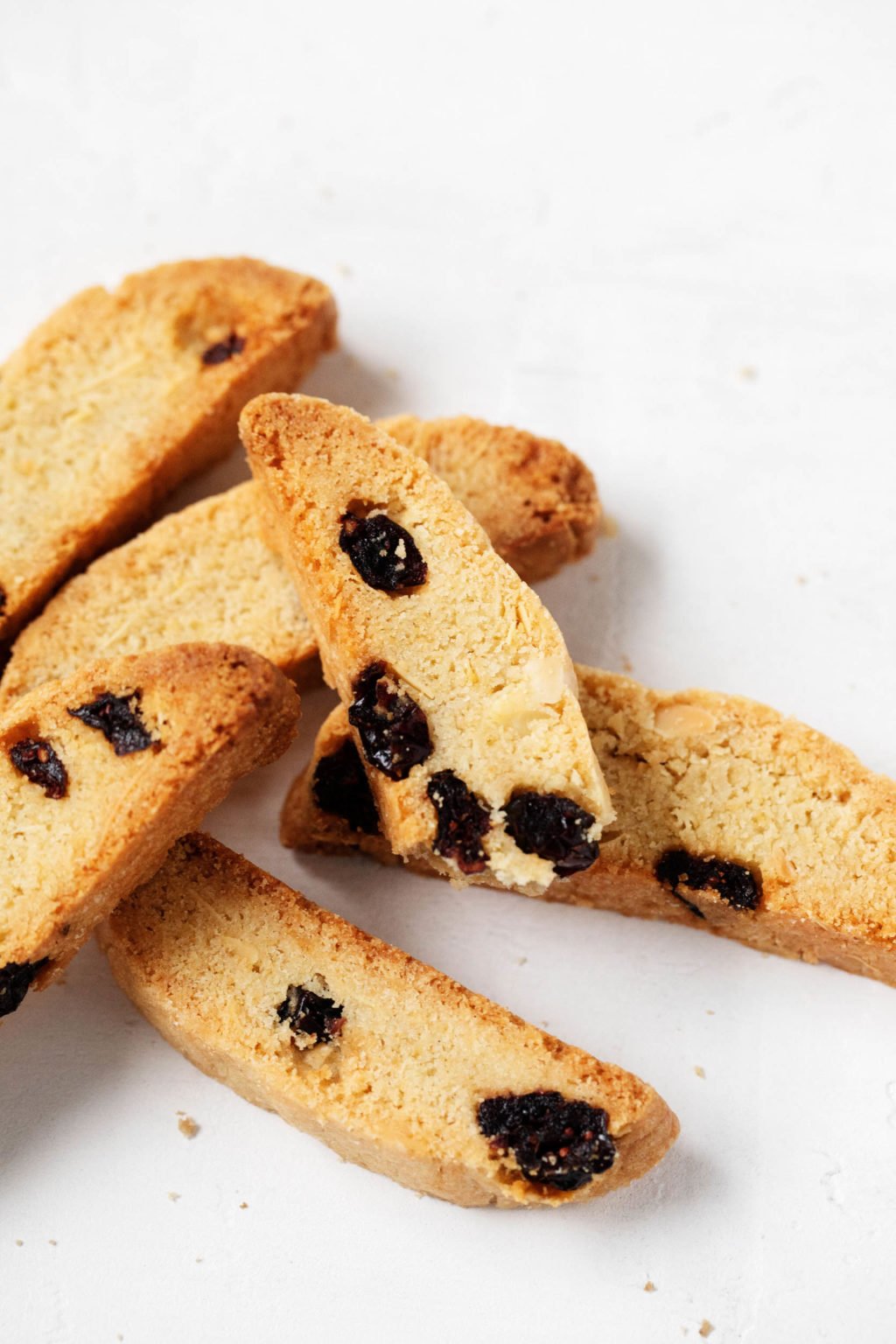  A small pile of vegan biscotti cookies, studded with cranberries.