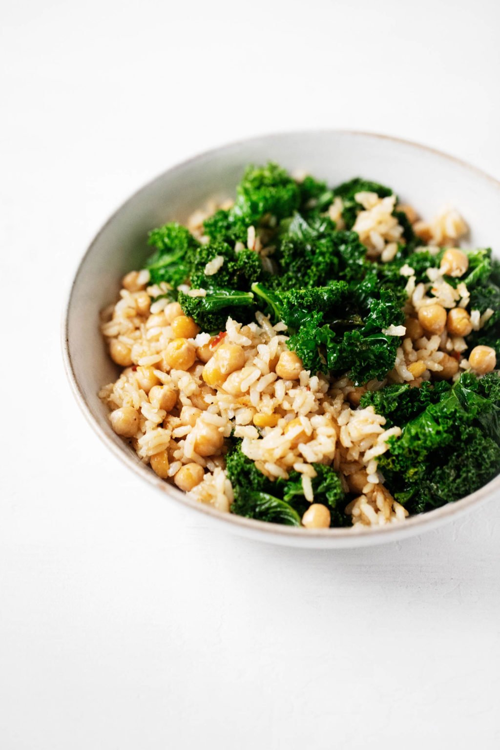 A grain, green and bean dish is nestled into a serving bowl.