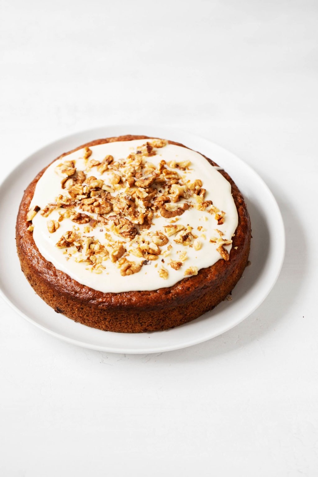 A round, simply decorated vegan banana cake.