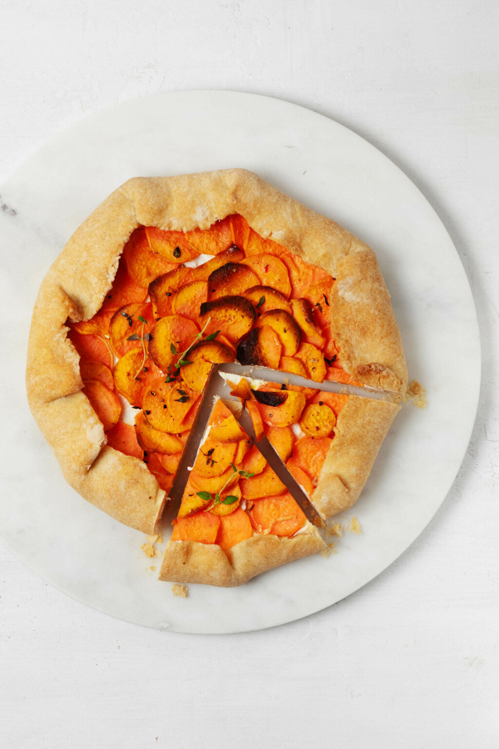 An overhead image of a festive, savory galette made with sweet potatoes.