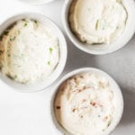 Four small, white ceramic pinch bowls are filled with a 5-ingredient tofu cream cheese.