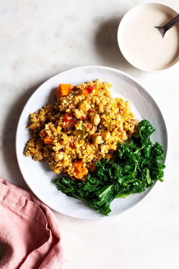 Simple Baked Bulgur & Chickpeas Dish Recipe - This dish of simple baked bulgur & chickpeas is rich in fiber, protein, an array of phytonutrients, and it’s easy to prepare. Served with a bright, creamy tahini dressing! #chickpeas #dish #bakedbulgur #maindish #easydinnerrecipe