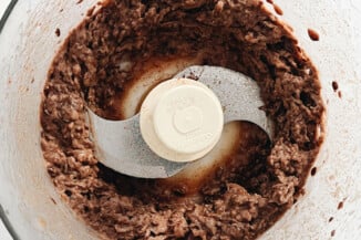 A food processor has just been used to make a puréed black bean spread.