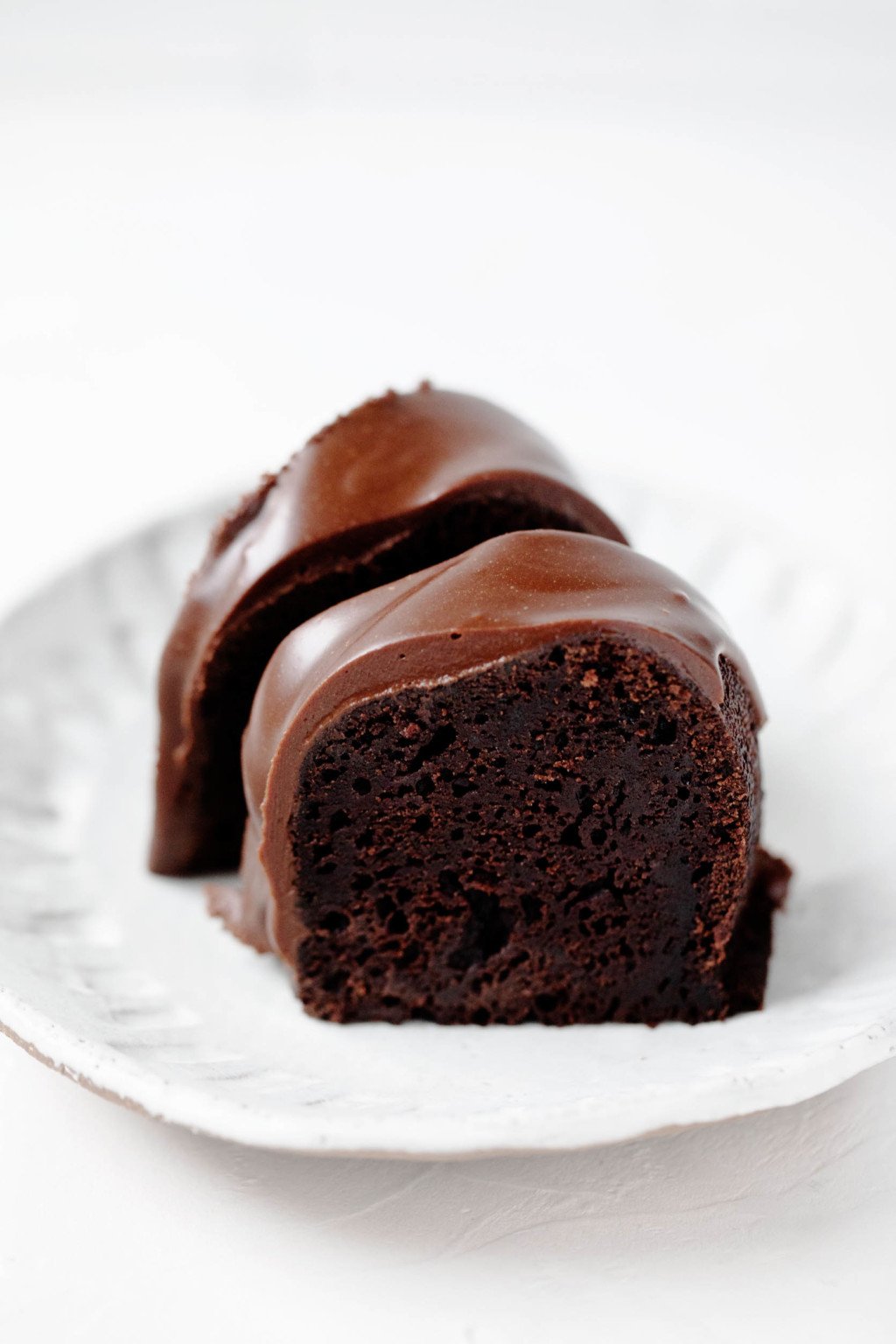 Two crosswise slices of a vegan chocolate bundt cake.