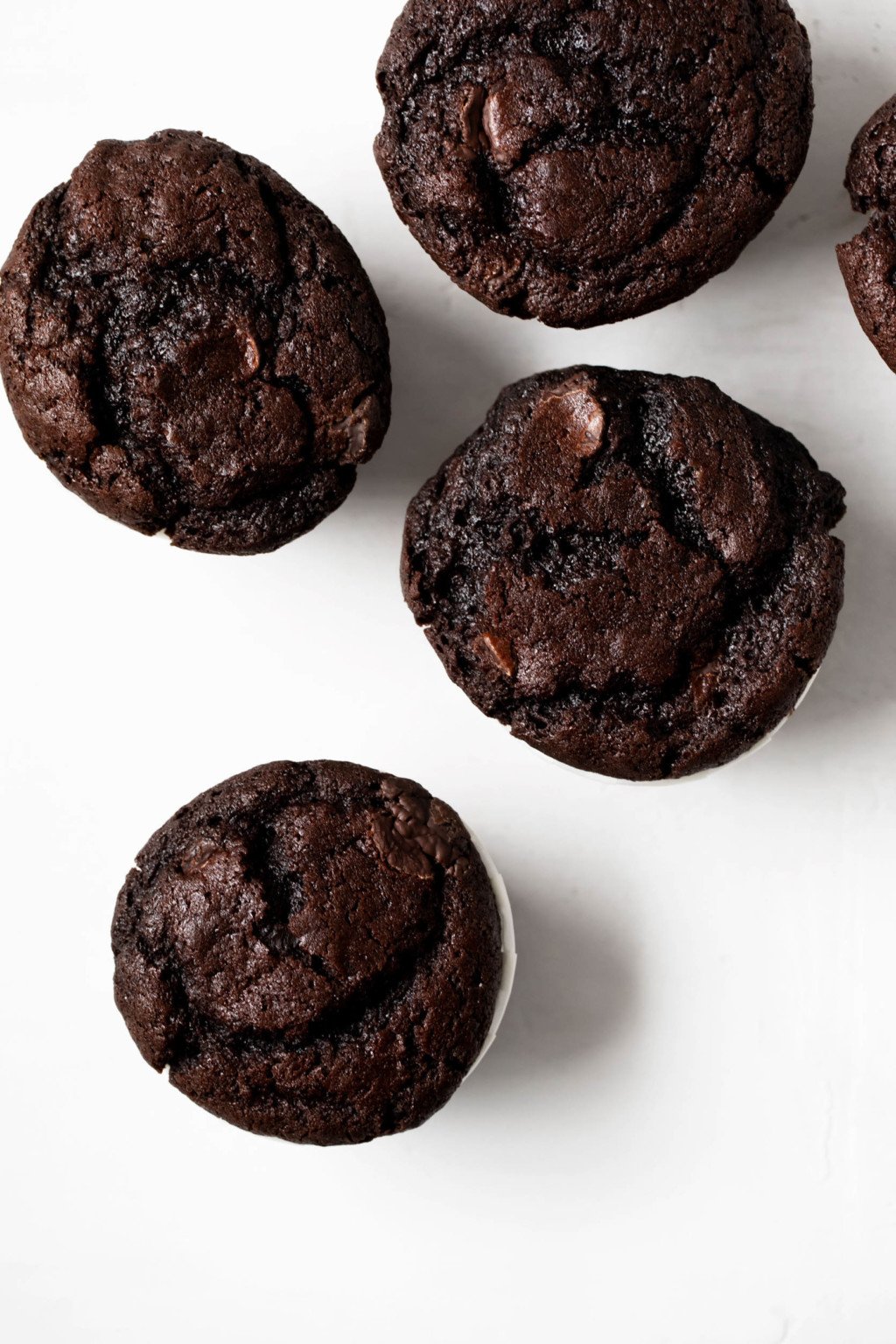 An overhead image of a few freshly baked vegan treats, which have been baked in cupcake liners.