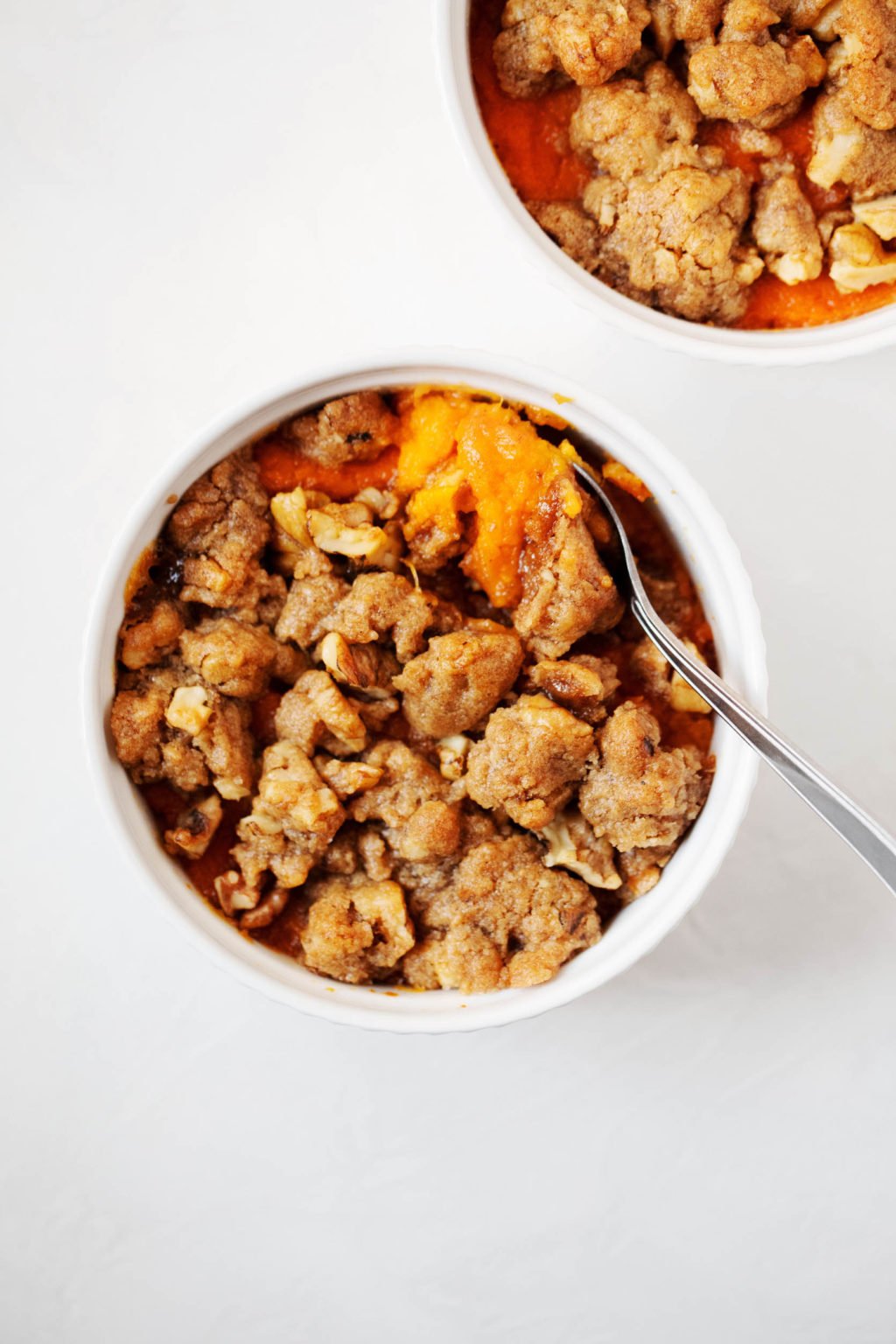 A small ramekin holds a single serving of vegan sweet potato casserole.