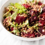 A vibrant, colorful bowl of a vegan lentil beet salad.