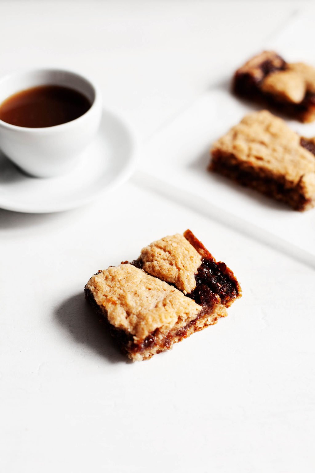 A sweet afternoon treat is laid out on a white surface, with a cup of tea nearby.