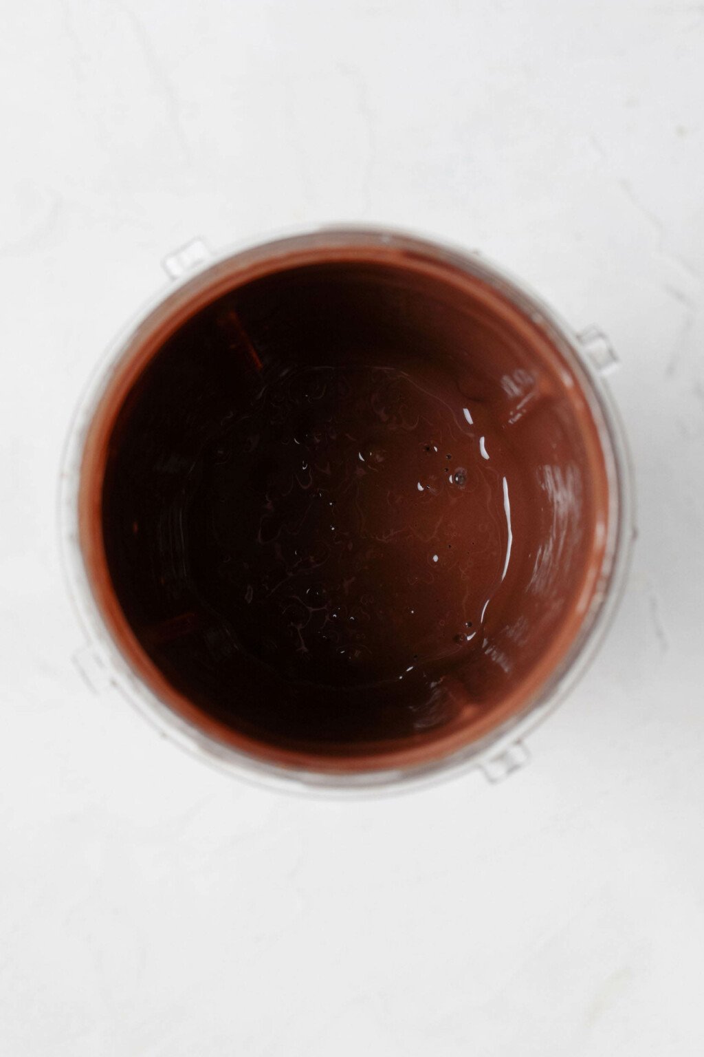 An overhead image of a portable blender, which is filled with a homemade chocolate pudding mixture.