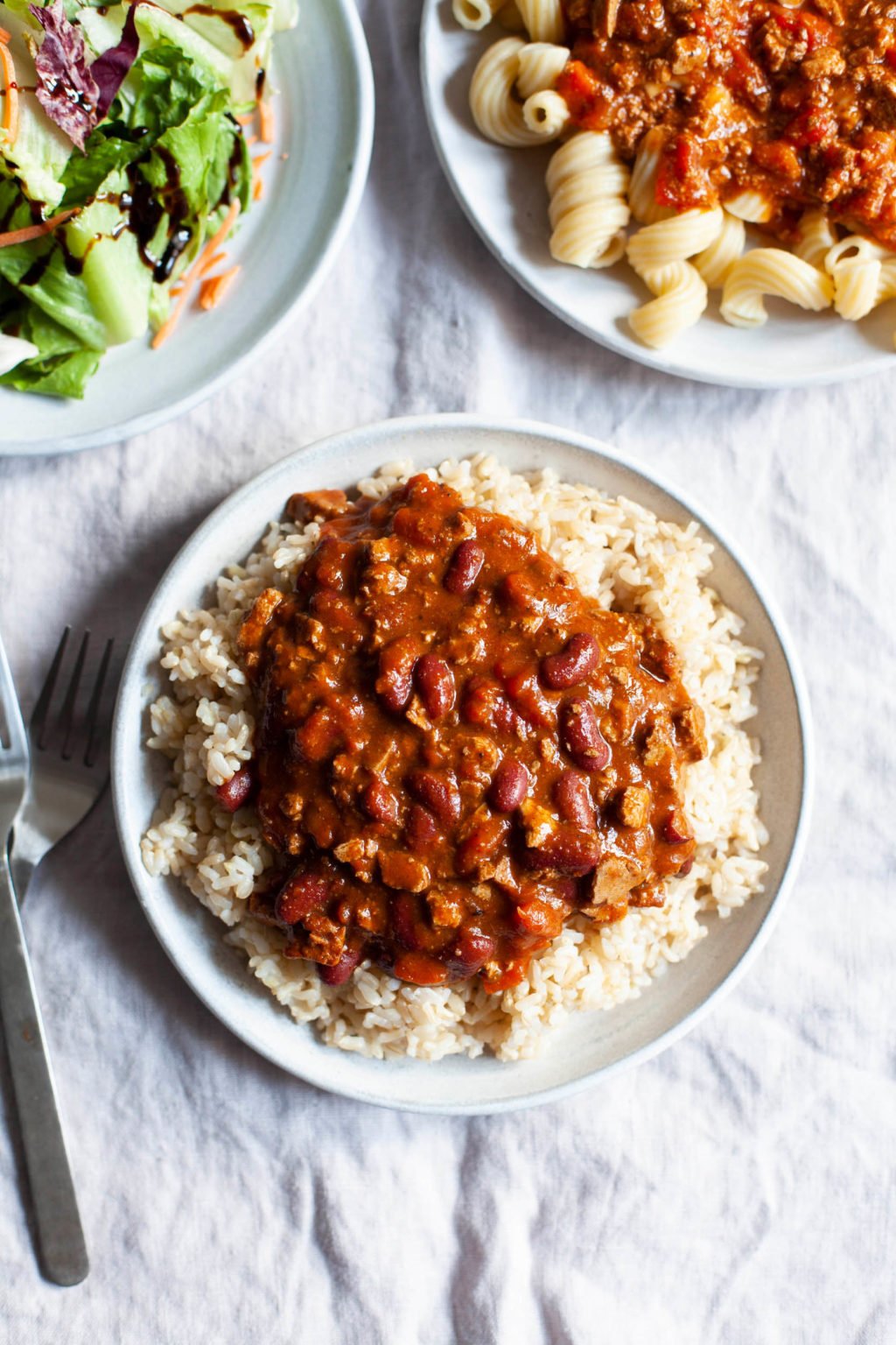 Nasoya's Plantspired Meal Solutions feature an easy vegan chili, which has been scooped onto a plate of brown rice.