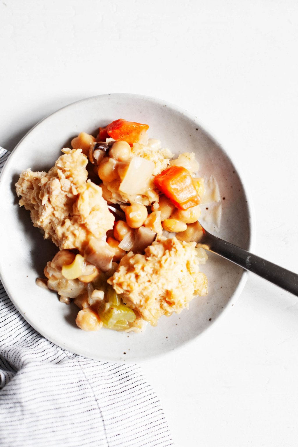 A small ceramic plate holds a portion of a baked comfort food dish.