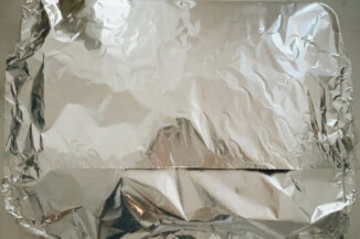 A baking sheet has been tightly covered with foil.