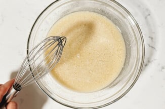 A liquid mixture of vegetable oil and non-dairy milk rests on a white surface.