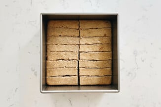 A square baking pan has been filled with 16 even pieces of cake.