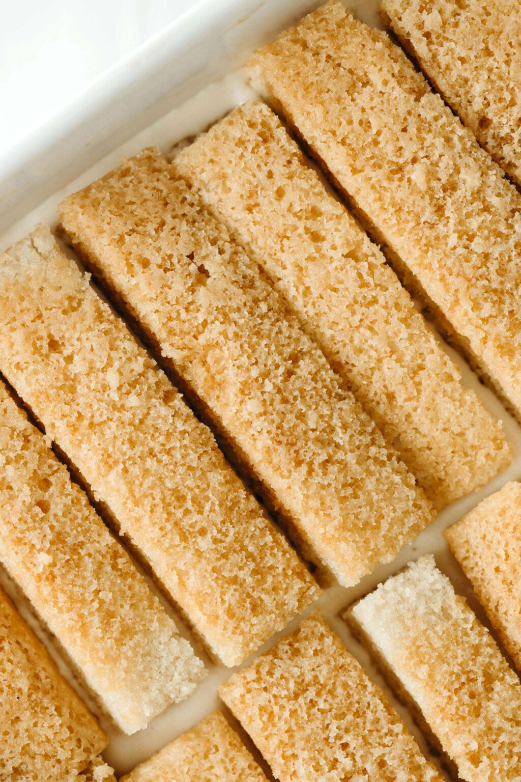 Slices of a vegan vanilla cake have been soaked in coffee.