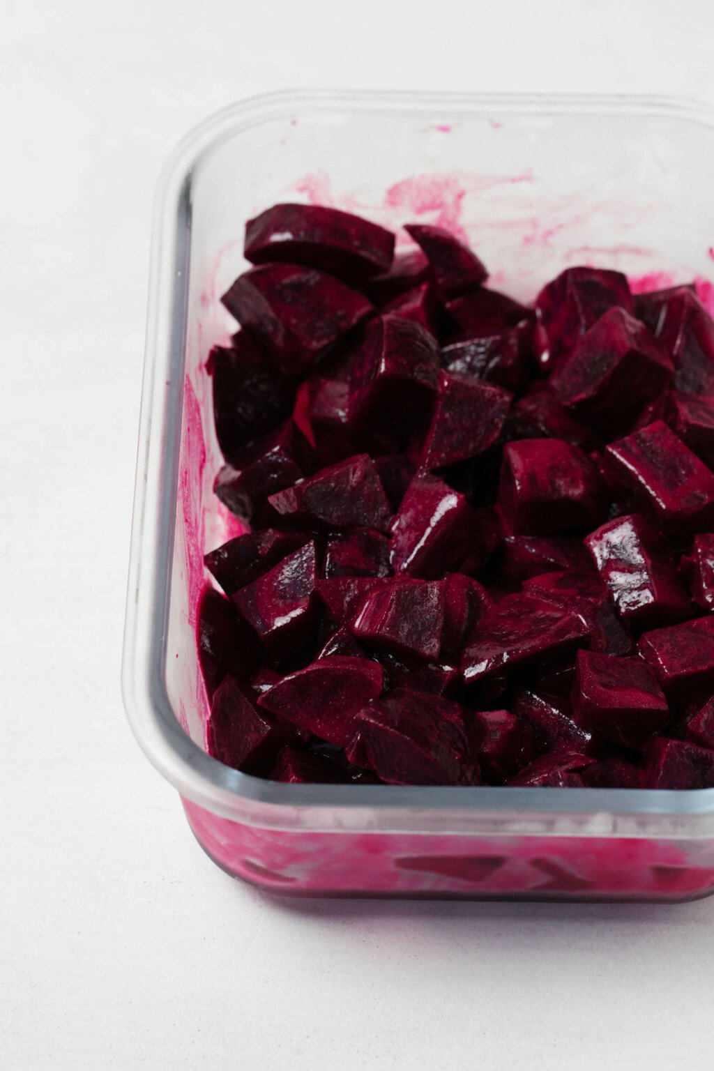 Deep crimson, marinated beets have been topped with a simple vinaigrette.
