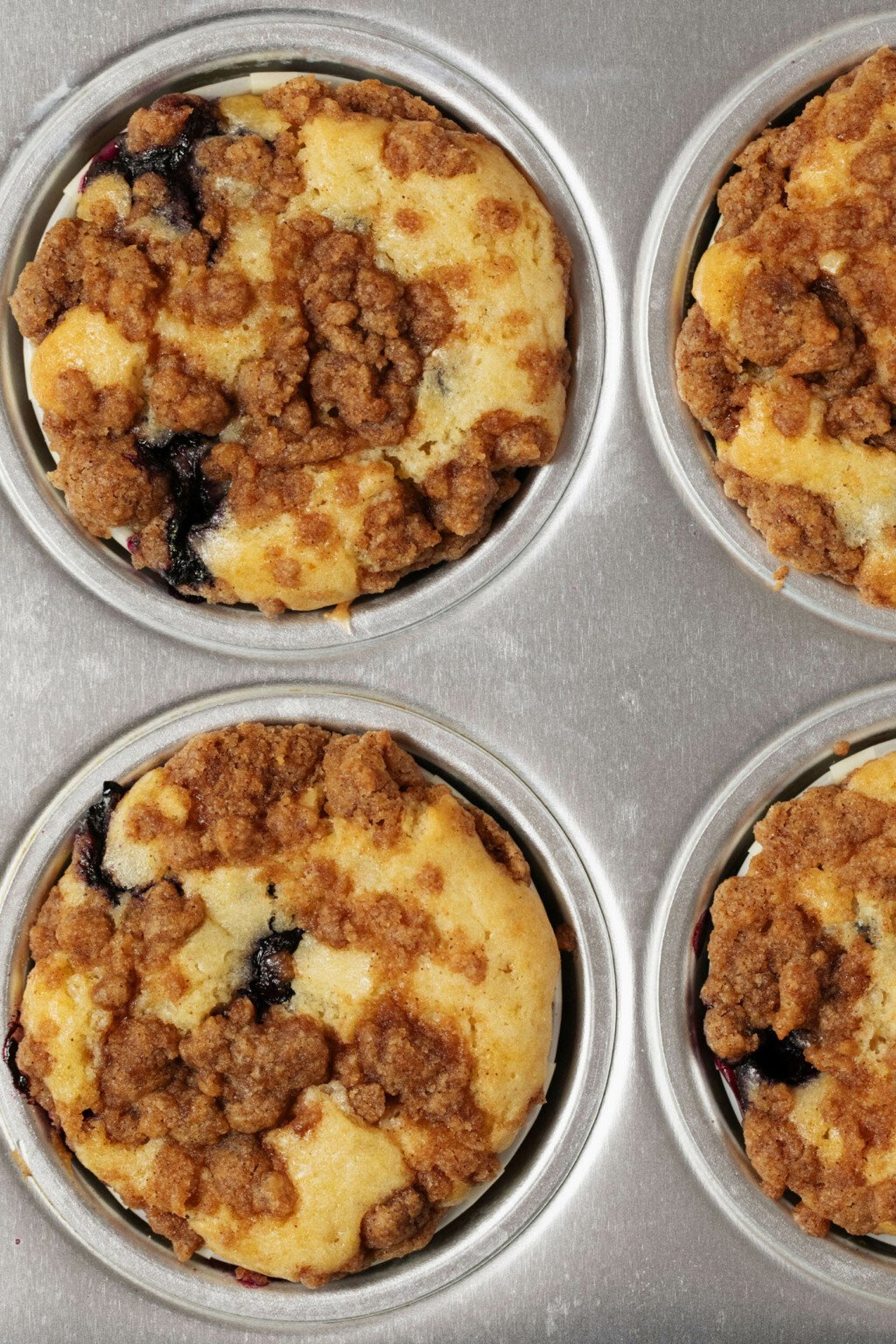 An overhead image of freshly baked muffins, covered with a streusel topping.