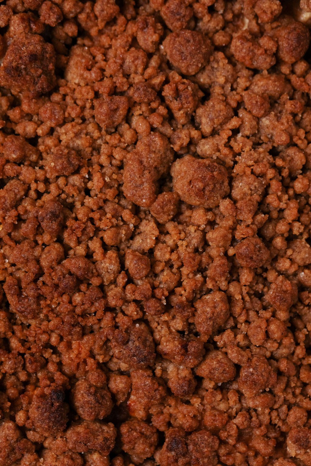 An overhead image of a deep golden brown, crumb topping in baking.