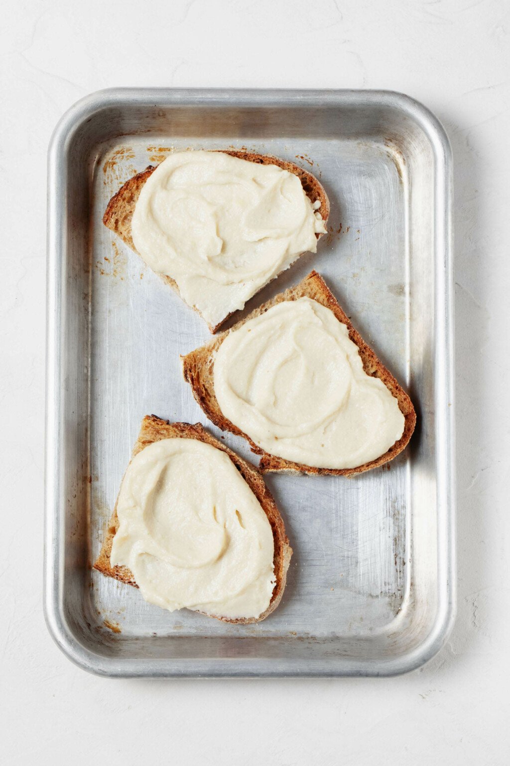 Slices of toast have been topped with a soft, creamy plant-based cheese.