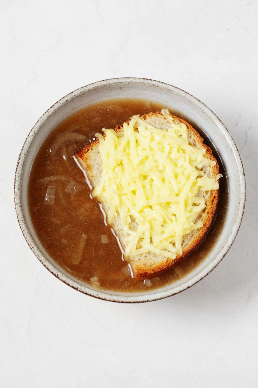 An overhead image of a bowl of French onion soup.
