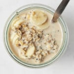 An overhead image of the mouth of a jar, which has been filled with plant-based overnight oats.