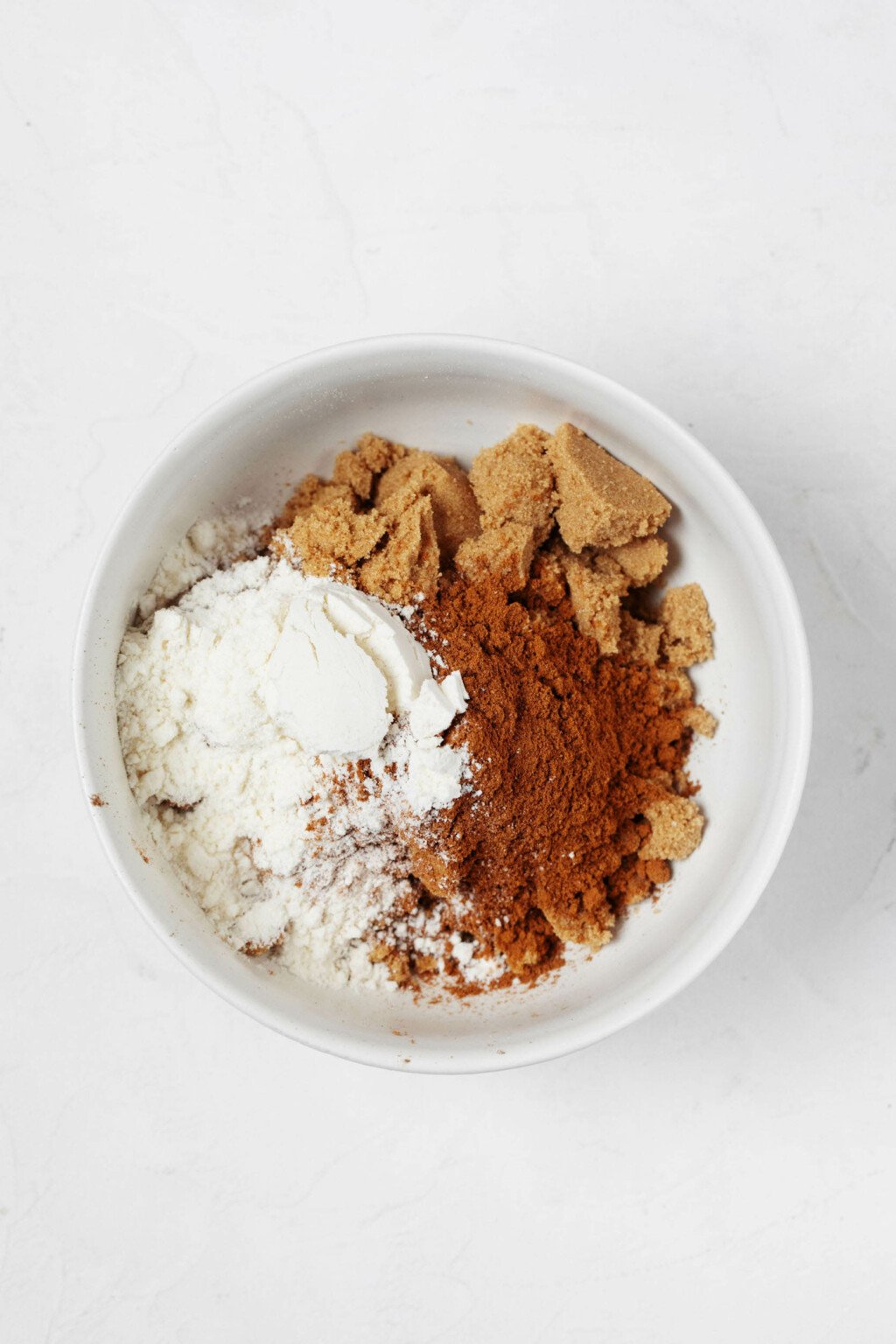 A small, pinch bowl contains cinnamon, brown sugar, and flour.