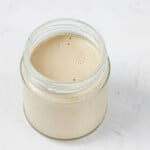 An overhead image of a creamy balsamic Dijon tahini dressing.