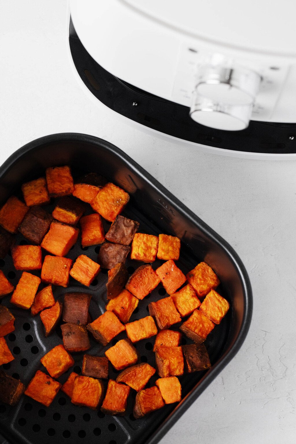 A tabletop appliance is used to cook cube vegetables.
